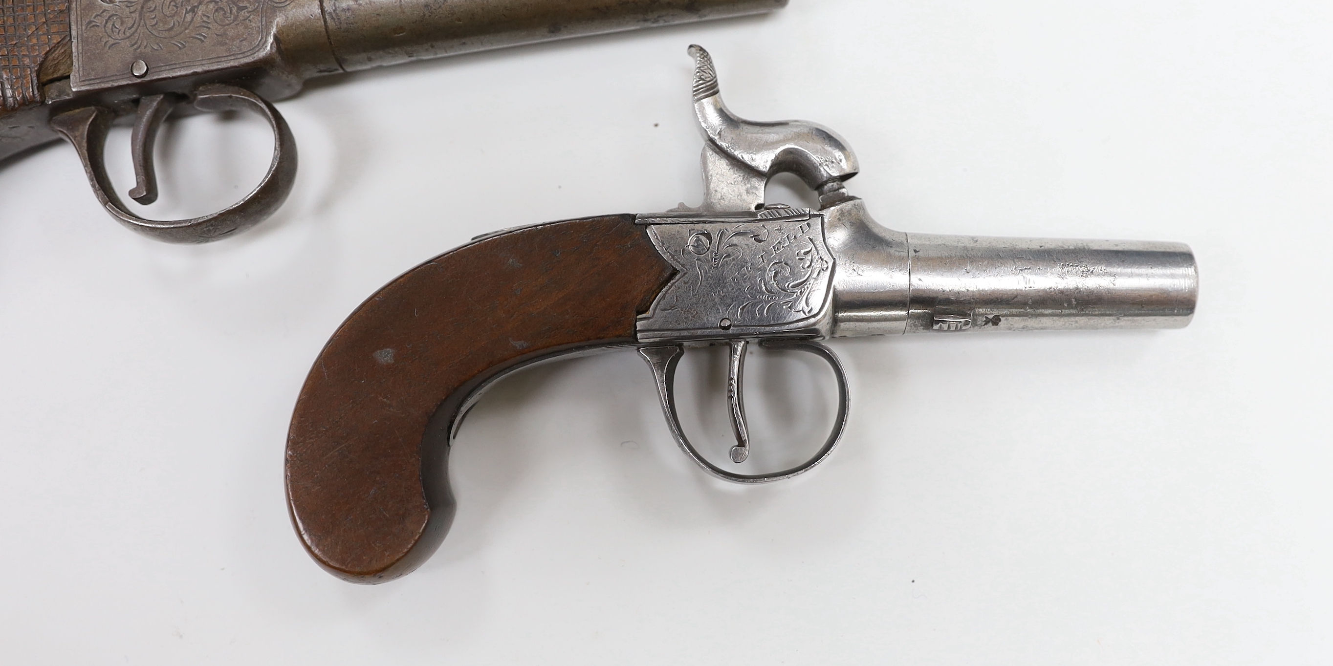 Two early 19th century percussion cap pocket pistols with turn off barrels, one signed ‘Young, Sheffield’ and a percussion cap boot pistol (3)
